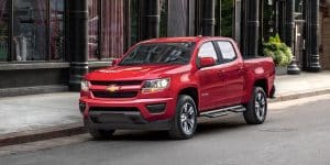 2018 Chevrolet Colorado red color park on road city background hd wallpaper